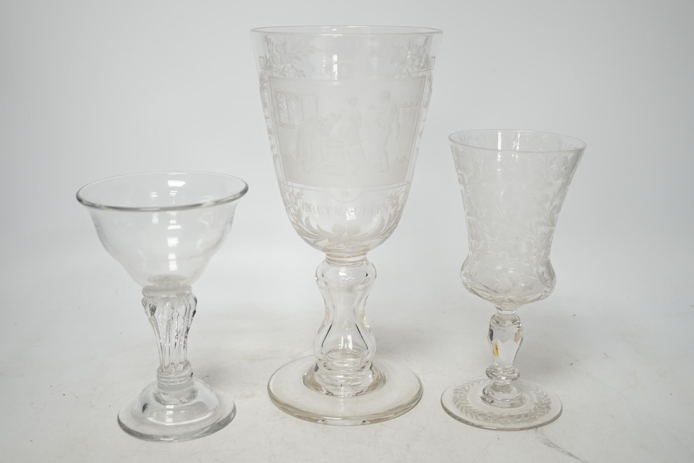 An 18th century sweetmeat glass, a 19th century large wheel engraved ‘Gretna Green’ goblet and a similar floral engraved glass, tallest 23cm. Condition good